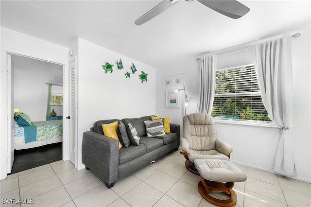 living room with light tile patterned floors and ceiling fan