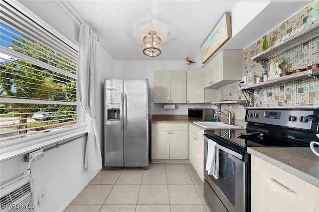 kitchen featuring appliances with stainless steel finishes, light tile patterned flooring, sink, and tasteful backsplash