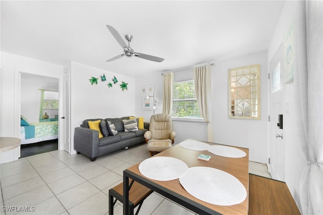 interior space with light tile patterned flooring and ceiling fan