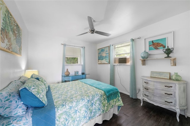 bedroom with ceiling fan, dark wood-type flooring, and multiple windows