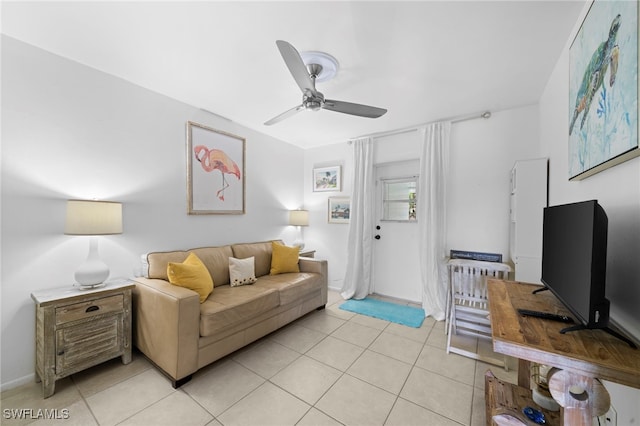 living area featuring ceiling fan and light tile patterned flooring