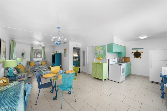 kitchen featuring white appliances and an inviting chandelier