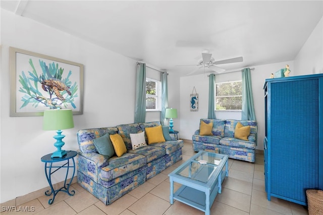 living area with ceiling fan and light tile patterned floors