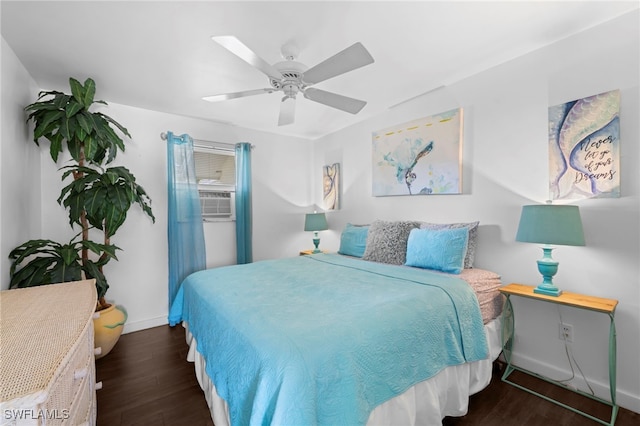 bedroom with cooling unit, dark wood finished floors, a ceiling fan, and baseboards