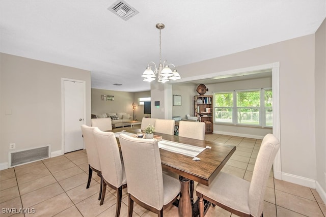 tiled dining area featuring a notable chandelier