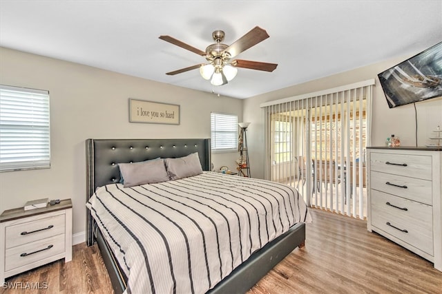 bedroom featuring ceiling fan, hardwood / wood-style floors, and access to outside