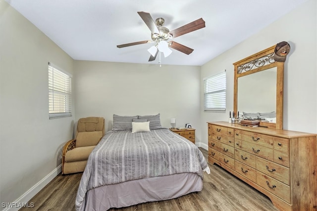 bedroom with ceiling fan and dark hardwood / wood-style floors