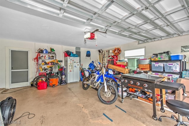 garage with white fridge with ice dispenser and a garage door opener