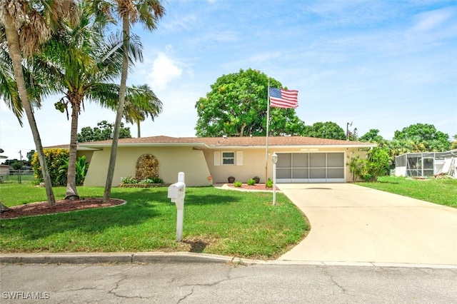 single story home featuring a garage and a front yard