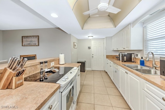 kitchen featuring ceiling fan, white electric stove, white cabinetry, sink, and light tile patterned flooring