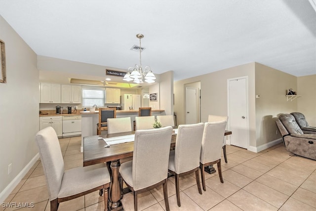 dining space featuring sink, a notable chandelier, and light tile patterned flooring