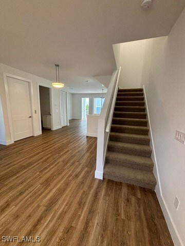 stairs featuring hardwood / wood-style floors