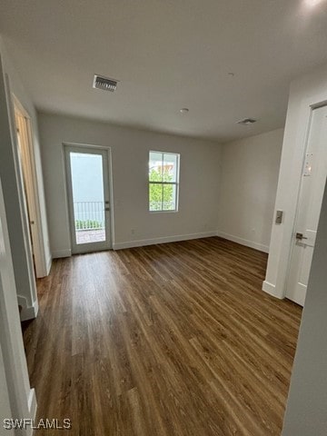 unfurnished room with dark hardwood / wood-style floors