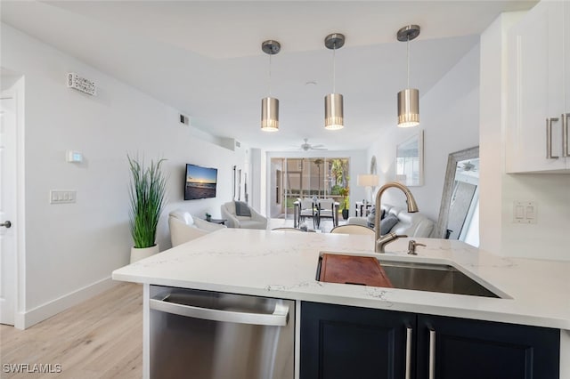 kitchen featuring ceiling fan, sink, dishwasher, light hardwood / wood-style floors, and hanging light fixtures