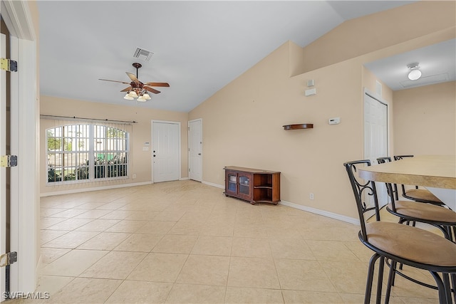 tiled living room featuring ceiling fan and vaulted ceiling