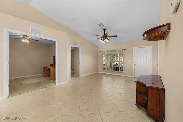 tiled spare room with ceiling fan and vaulted ceiling