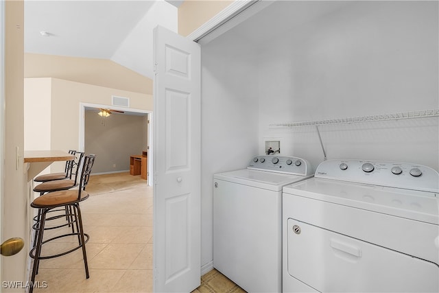 laundry room featuring washer and dryer and light tile patterned flooring