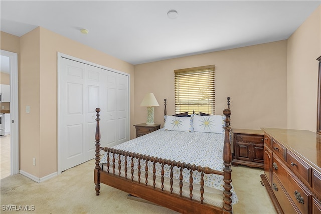 bedroom featuring a closet and light carpet