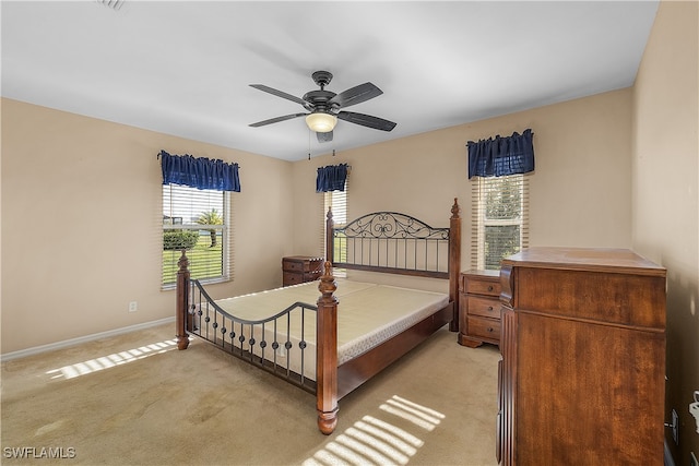 bedroom with light carpet and ceiling fan