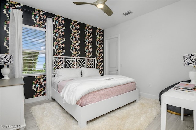 bedroom with ceiling fan and light wood-type flooring