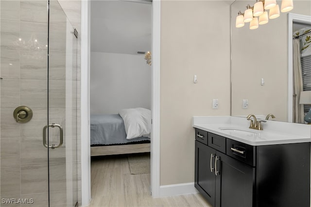 bathroom featuring wood-type flooring, walk in shower, and vanity