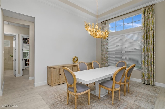 dining space with crown molding and an inviting chandelier