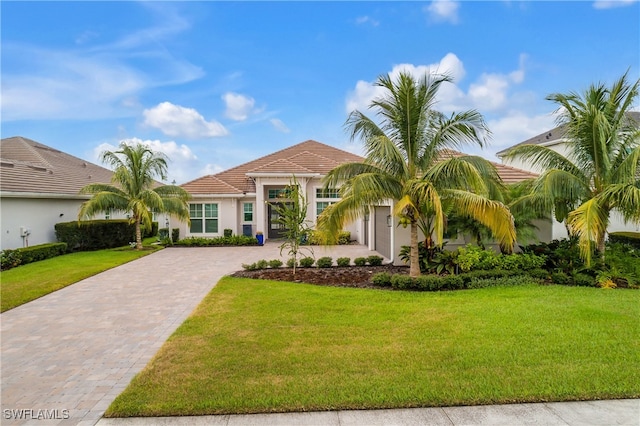 view of front of property with a front lawn and a garage