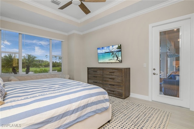 bedroom with ceiling fan, crown molding, and a tray ceiling