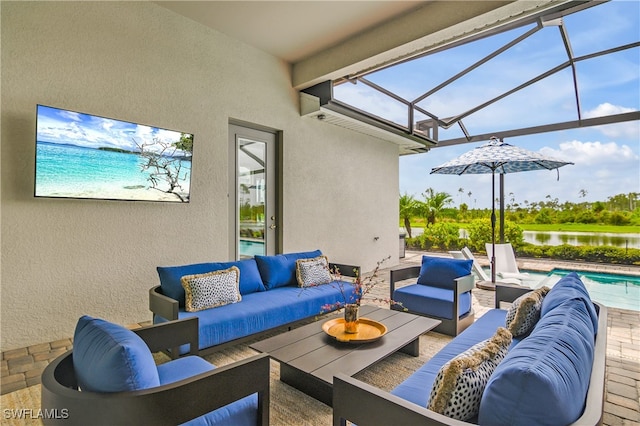 view of patio / terrace featuring an outdoor living space, a water view, and a lanai