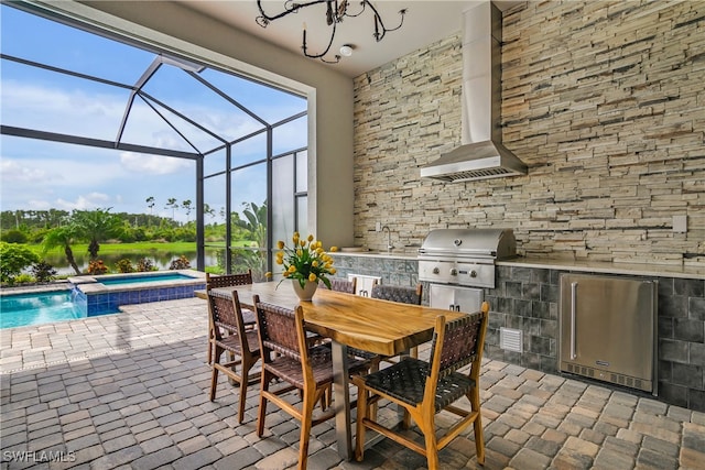 view of patio / terrace featuring exterior kitchen, sink, a lanai, grilling area, and a pool with hot tub