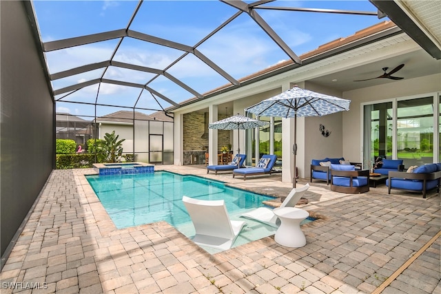 view of pool featuring ceiling fan, a patio area, a lanai, and an in ground hot tub