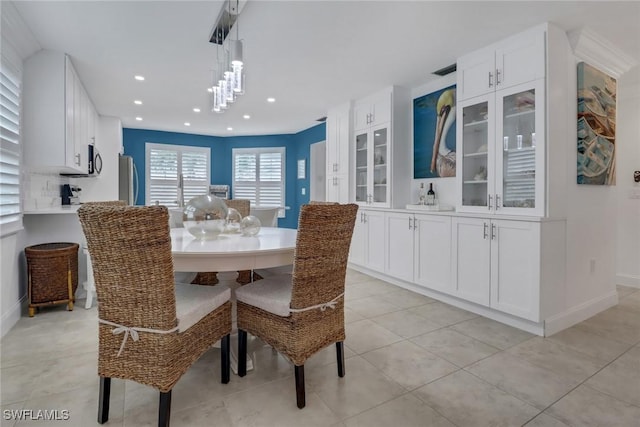 dining room with light tile patterned flooring, recessed lighting, and baseboards