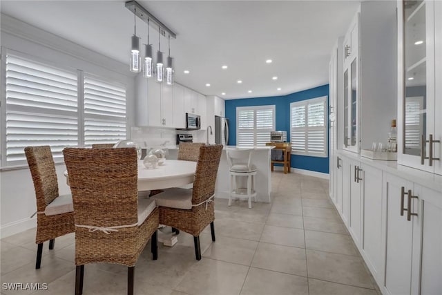 dining area featuring light tile patterned floors, recessed lighting, and baseboards