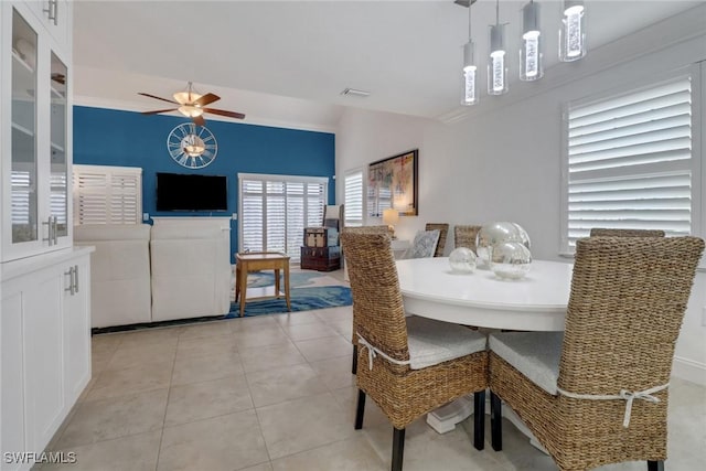 dining area featuring light tile patterned floors, visible vents, and a ceiling fan