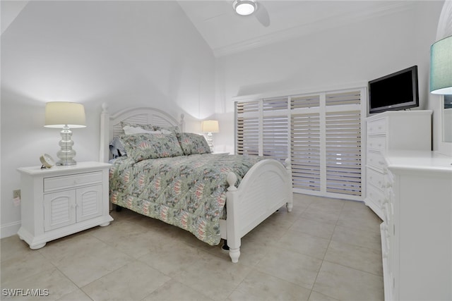 bedroom with light tile patterned floors, ceiling fan, ornamental molding, and vaulted ceiling