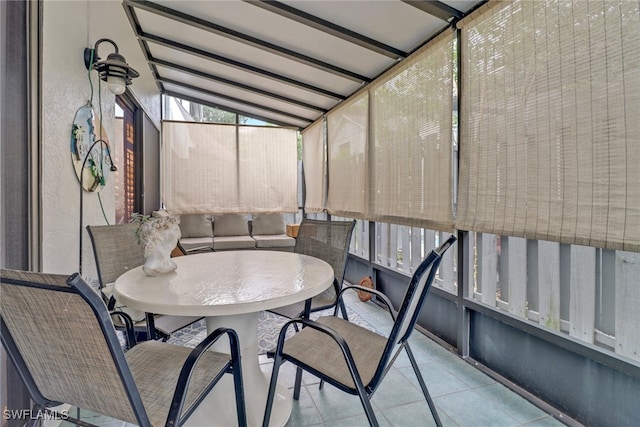 sunroom featuring vaulted ceiling