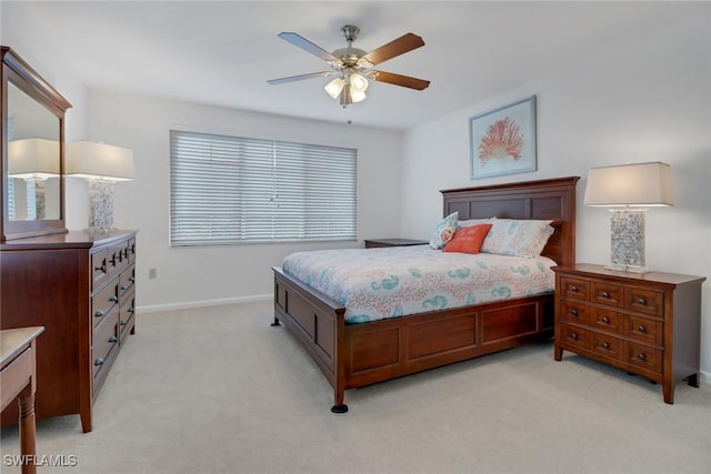 bedroom featuring ceiling fan, baseboards, and light carpet