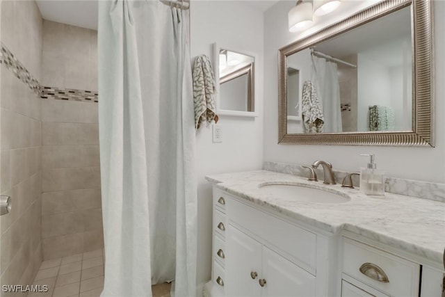 full bathroom featuring vanity and a tile shower