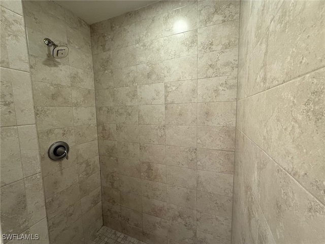 bathroom with tiled shower