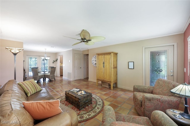 tiled living room with ceiling fan and ornamental molding