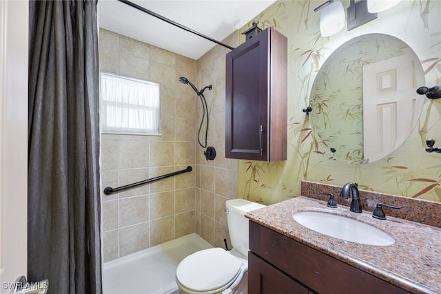 bathroom featuring toilet, vanity, and curtained shower