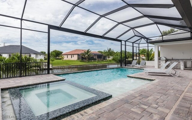 view of pool featuring a lanai, a patio, and an in ground hot tub