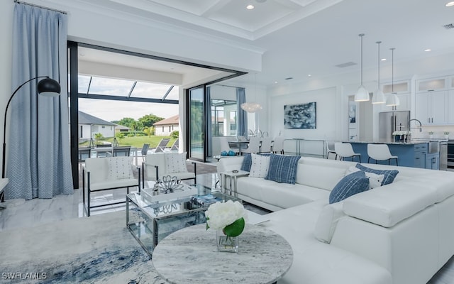 living room with coffered ceiling, crown molding, and sink