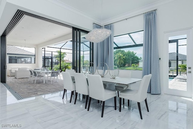 dining area with ornamental molding and a chandelier