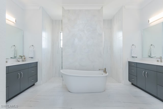 bathroom featuring vanity, ornamental molding, a tub, and tile walls