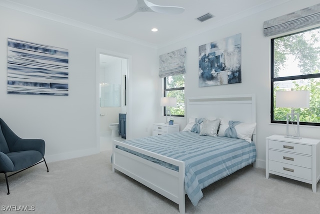 bedroom featuring ensuite bathroom, crown molding, ceiling fan, and light carpet