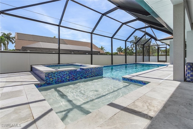 view of pool featuring a lanai, a patio area, and an in ground hot tub