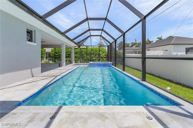 view of pool featuring glass enclosure, a patio area, and an in ground hot tub