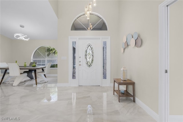 entryway with a towering ceiling