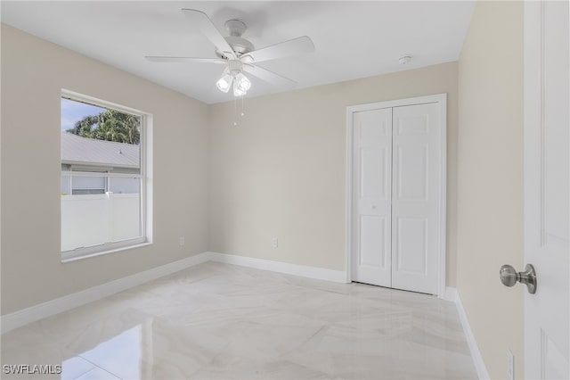 bedroom featuring ceiling fan, a closet, and light tile patterned floors